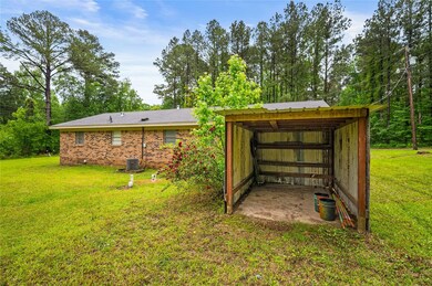 View of pole building with a lawn and cooling unit