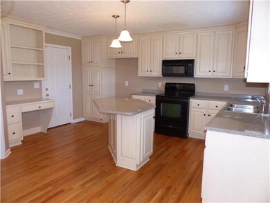 The kitchen has an abundance of cabinet space, a built in desk, and large island. 