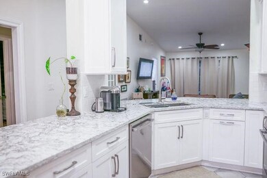 Kitchen with light stone countertops, stainless st
