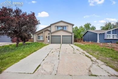 View of front of property featuring concrete driveway and a garage
