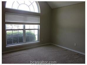 Carpeted empty room with baseboards