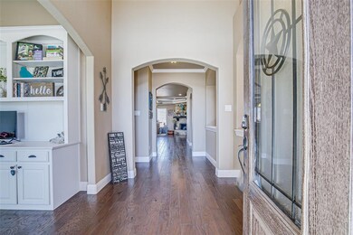 An inviting foyer with gorgeous hardwood floors, c