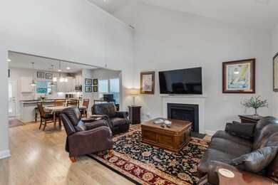 Living room featuring high vaulted ceiling and lig