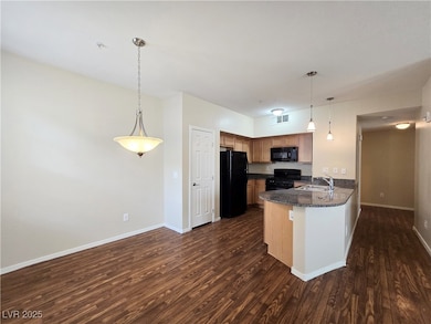 Kitchen featuring black appliances, a sink, a peni