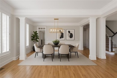 Virtually staged Dining space featuring ornate col