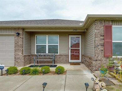 Property entrance featuring brick siding and roof with shingles