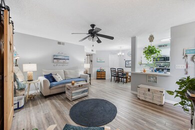 Living room with a barn door, light hardwood / woo