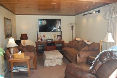 Living room w/ knotty pine ceiling.