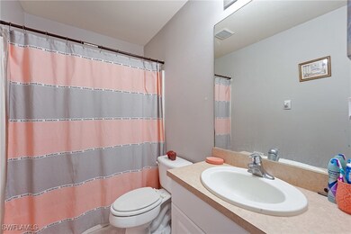 Full bath featuring vanity, toilet, and curtained