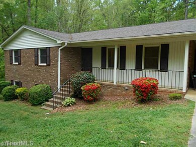 Facade/Exterior Front. Beautiful spot to sit and enjoy your well maintained front lawn.