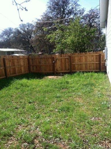 The fenced back yard.