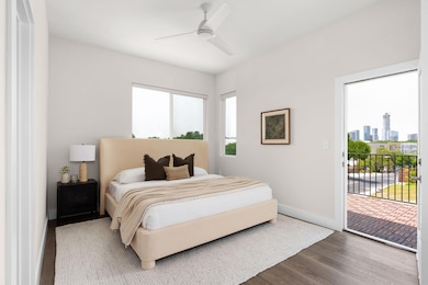Bedroom with access to exterior, wood finished fl
