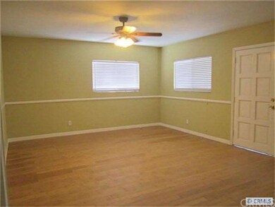 Spacious Living Room with Ceiling Fan & Laminated 