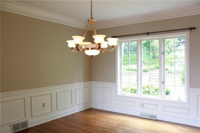 The dining room with detailed dentil crown molding