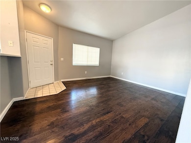 Entrance foyer featuring baseboards and dark wood-