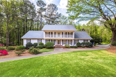Colonial house with a front lawn and a porch