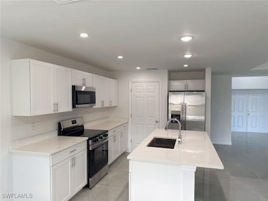 Kitchen with white cabinets, stainless steel appli