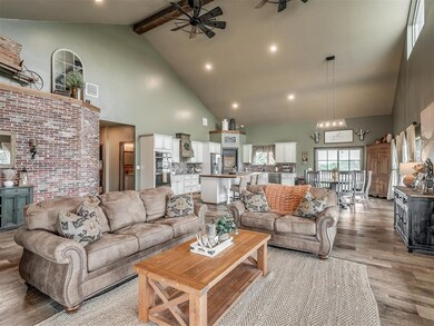 Living area with high vaulted ceiling, a ceiling fan, light wood finished floors, beamed ceiling, and recessed lighting