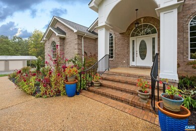 The covered front porch is surrounded by vibrant c