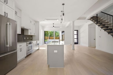 Kitchen with light wood-type flooring, a sink, st