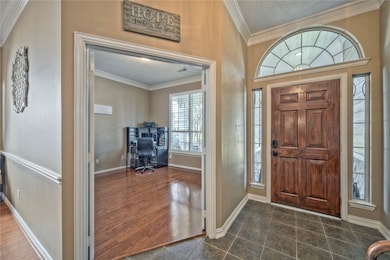 Entry way.  Notice the beautiful crown molding and wood and tile floors.