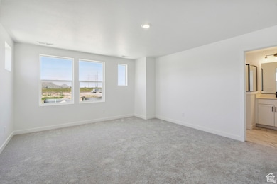 Spare room with light colored carpet and recessed lighting