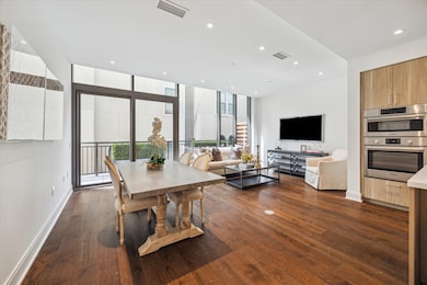 Living/Dining space with large floor-to-ceiling wi