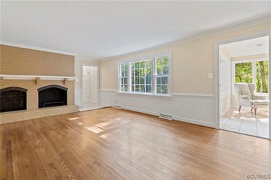 Unfurnished living room featuring crown molding, a