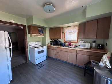Kitchen featuring a sink, dark wood-style flooring