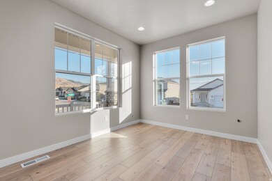 Spare room featuring plenty of natural light, light wood-style flooring, and recessed lighting