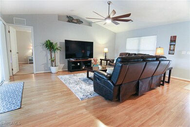 Living room with ceiling fan, light wood-type floo