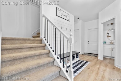 Stairway featuring wood finished floors and baseboards