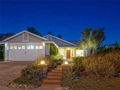 TWILIGHT PHOTO TO FORMAL FRONT ENTRY WITH NEWER GARAGE DOOR AND AUTO IRRIGATED DROUGHT RESISTANT LANDSCAPED FRONT YARD.