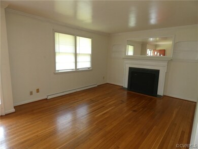 Unfurnished living room with ornamental molding, a