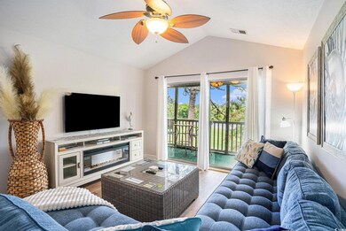 Living room featuring lofted ceiling, wood finishe