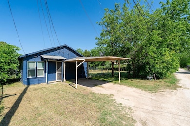 View of front of home with dirt driveway and a fro