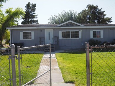 View of front of house with a gate and a shingled