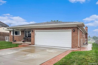 Ranch-style house featuring brick siding, a gate, driveway, and a garage