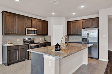 A wonderful, spacious, inviting kitchen brings family and friends together.
