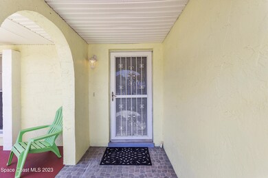 Front entrance w/ decorative storm door