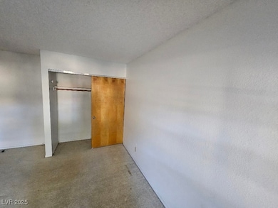Unfurnished bedroom featuring a textured ceiling a