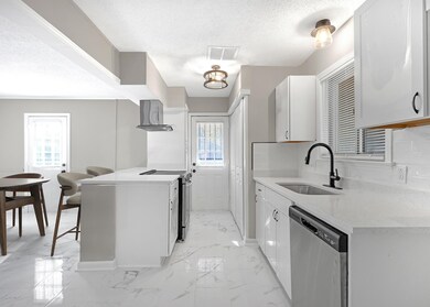 Kitchen featuring sink, a textured ceiling, white 