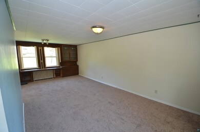 Empty room with radiator heating unit and light co