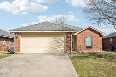 Ranch-style house with a garage, cooling unit, and