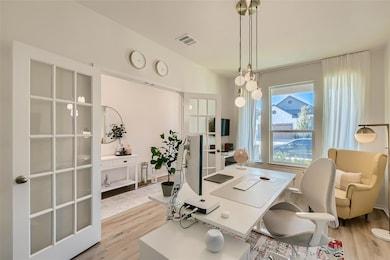 Office area with light wood-style floors