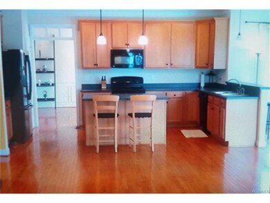 VIEW OF KITCHEN FROM FAMILY ROOM. DINING ROOM BEYO