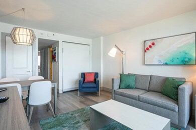 Living room with wood finished floors and baseboar