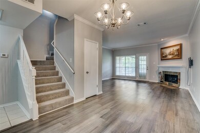 Living room featuring an inviting chandelier, wood