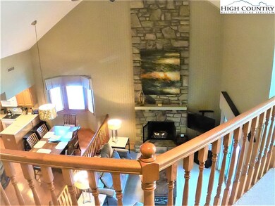 View from upper level foyer, soaring ceilings add