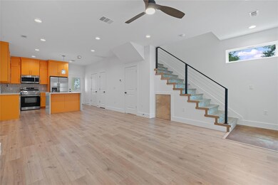 Kitchen with open floor plan, light countertops, 